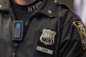 An NYPD officer models a body camera at a press event on Thursday. 